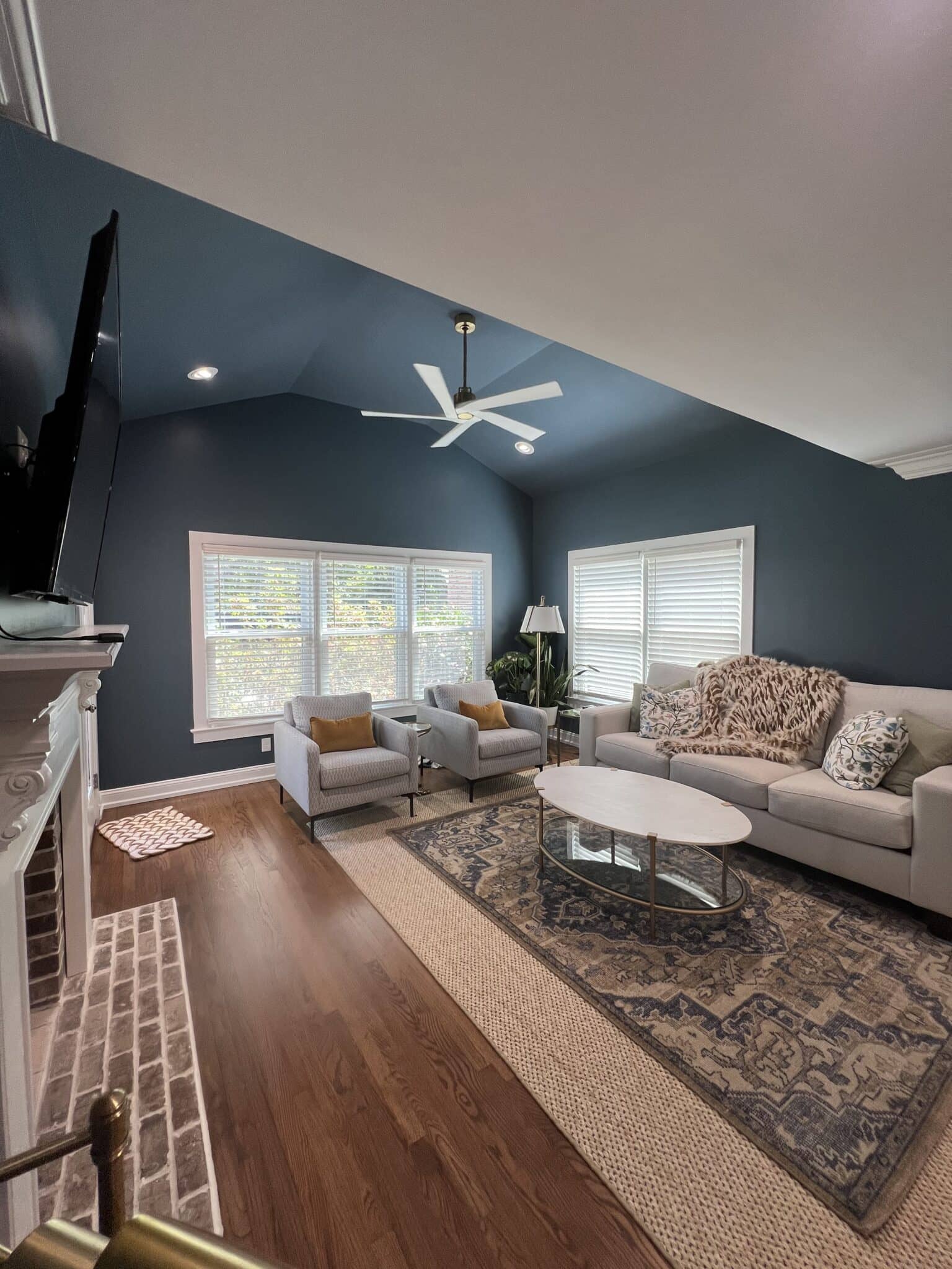 blue living room with new lighting and ceiling fan