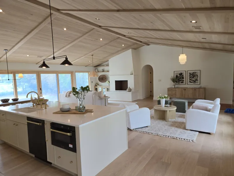 modern living room with can lights and chandelier